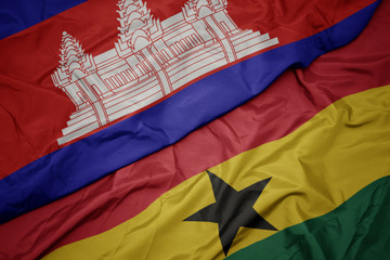 waving colorful flag of ghana and national flag of cambodia.