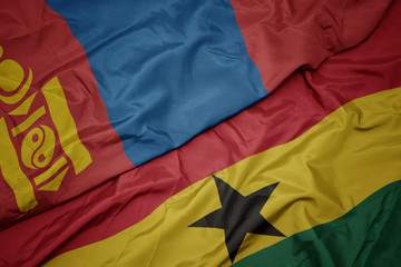 waving colorful flag of ghana and national flag of mongolia.