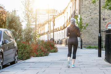 Woman running in the morning in streets of London
