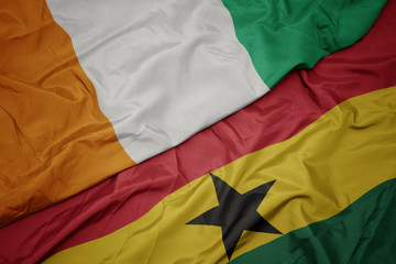 waving colorful flag of ghana and national flag of cote divoire.