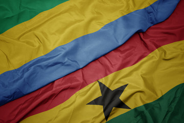 waving colorful flag of ghana and national flag of gabon.