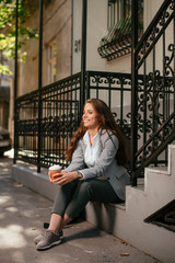 Beautiful businesswoman on coffee break. Young woman outdoors.