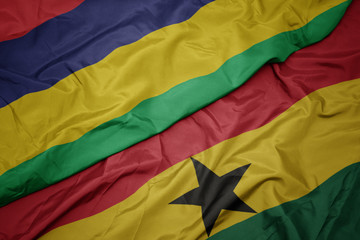 waving colorful flag of ghana and national flag of mauritius.