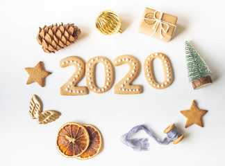 Ginger biscuits of the form of numbers and 2020 new year ginger cookies and xmas decoration frame on white background. Top view. Flat lay for Happy New Year.