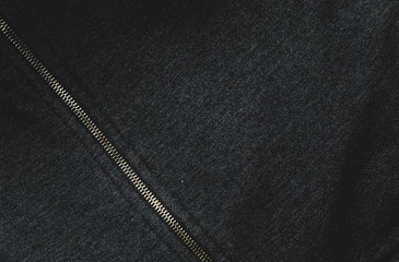 Background image Jacket. Patterns of black fabric and metal zipper. focus And a dark tone.