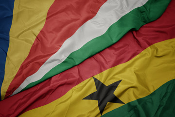 waving colorful flag of ghana and national flag of seychelles.