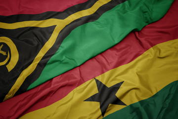 waving colorful flag of ghana and national flag of Vanuatu .