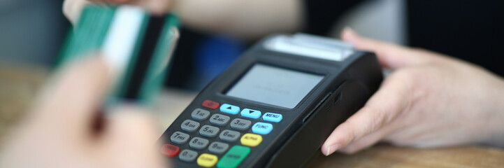 Cashier Hand Taking Plastic Credit Card to Payment