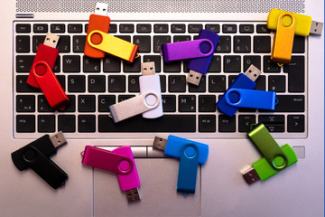 set of colourful usb flash drives on a keyboard
