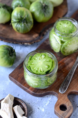 Pickled green tomatoes with herbs, horseradish, pepper and garlic