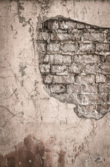 Old brick wall in a background image. Plastered Brickwall With Chipped Stucco Pieces. Red Textured Brick Wall With Damage Surface. Old Grunge Abstract Background