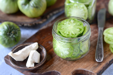 Pickled green tomatoes with herbs, horseradish, pepper and garlic