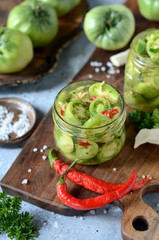 Pickled green tomatoes with herbs, horseradish, pepper and garlic