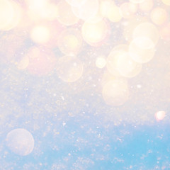 Winter sunny snow texture background with warm lens flare bokeh lights