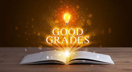 GOOD GRADES inscription coming out from an open book, educational concept