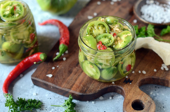 Pickled green tomatoes with herbs, horseradish, pepper and garlic