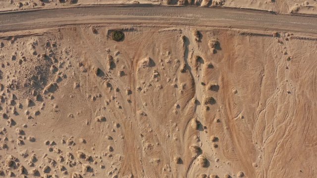 Desert aerial background with dirt roads, rocks and brush