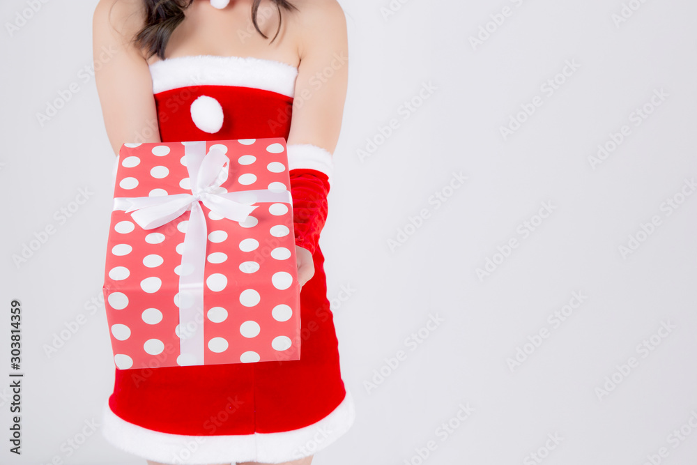 Wall mural Closeup hand woman holding present box in xmas day with surprise isolated on white background, arm girl happy give red gift box with wrap paper and white ribbon in Christmas holiday or birthday.