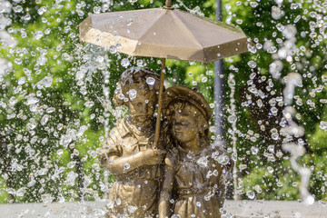 Fountain boy and girl under an umbrella in Samara