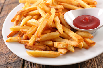 french fries and ketchup on plate - Powered by Adobe