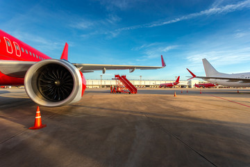 airplane engine in airport, with plane waiting for passenger, luggage, re fuel for take off again after landing at international airport for air transportation to clear blue sky