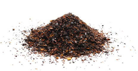 Roasted ground dry chili pepper pile, spicy chopped paprika isolated on white background