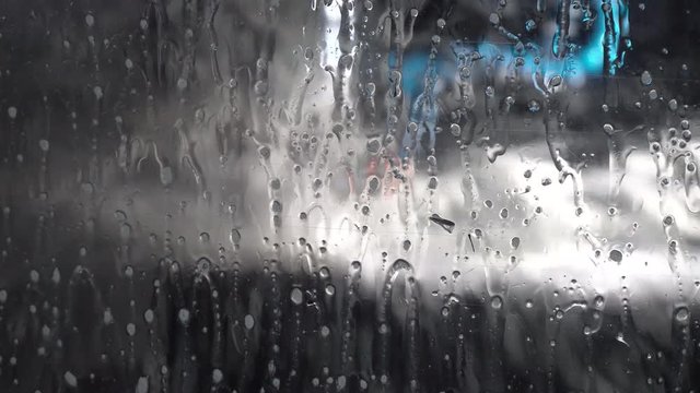 wet window of a working cnc milling machine with dripping drops