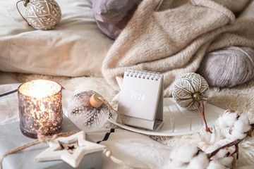 New Year 2020 calendar with lights in rustic server with wooden star toys and balls