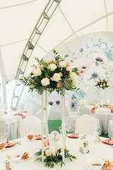 Decor of tables decorated with fresh flowers for a festive dinner, wedding