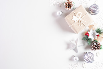 Christmas holidays composition Top view of gift box with Christmas tree decoration and red berries on white background with copy space for text.