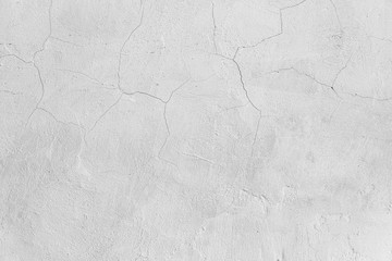 Rough white relief stucco with cracks wall texture background. blank for designers