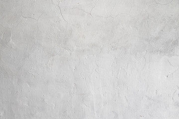 Rough white relief stucco with cracks wall texture background. blank for designers