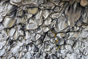 Wedge-shaped silver stone structures of Halsanefshellir cave, Reynisfjara beach at Vik i Myrdal, Iceland