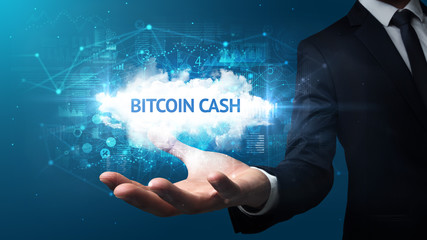 Hand of Businessman holding BITCOIN CASH inscription, successful business concept