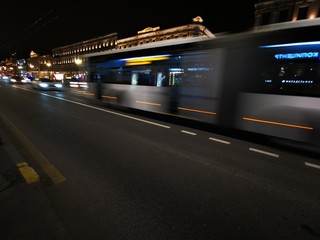 Fototapeta na wymiar Trace from the headlights of cars and buses in the evening city in St. Petersburg, Russia