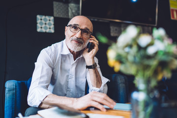 Senior man talking on phone and looking away