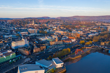 Obraz premium An aerial view at sunrise of Newport city centre, south wales United Kingdom, taken from the River Usk