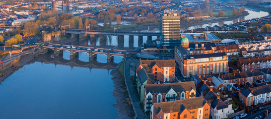 An aerial view at sunrise of Newport city centre, south wales United Kingdom, taken from the River Usk - obrazy, fototapety, plakaty