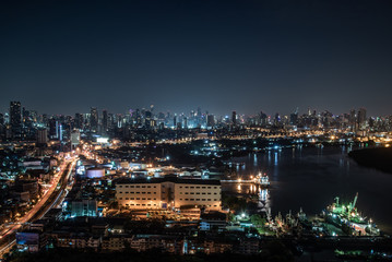 Beautiful view of Bangkok city, Beauty skyscrapers along Chaopraya river in the night, making the city modern style.