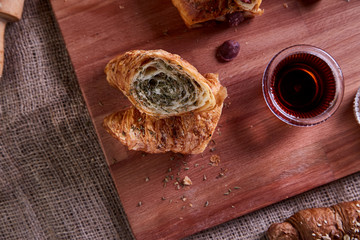 Freshly baked croissants and pate on wooden cutting board