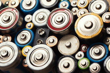 Used Alkaline batteries toxic waste recycling and ecology issues concept background - obrazy, fototapety, plakaty