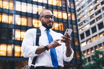 Ethnic bearded executive using smartphone - Powered by Adobe