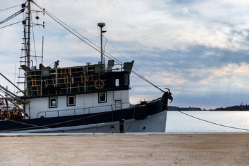 Fototapeta premium Old fishing boat anchored in the port