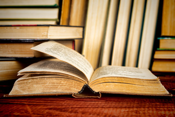 Open book on wood desk in the library room  for education background and back to school concept.
