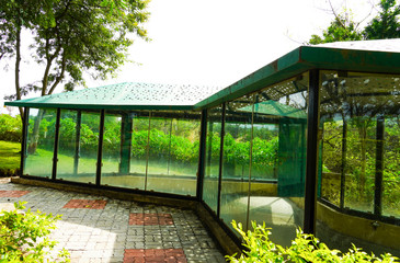 Natural Greenery Park With Glass House For Rest, Green Garden and Park.