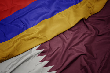 waving colorful flag of qatar and national flag of armenia.