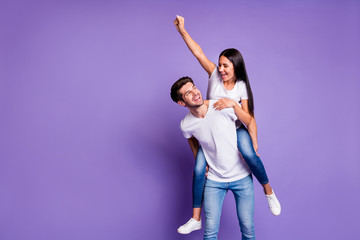 Photo of cheerful positive cute pretty nice couple of two people with her raising fist and him...