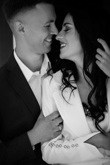 Beautiful loving couple is spending time together. Happy couple while walking through the city street..