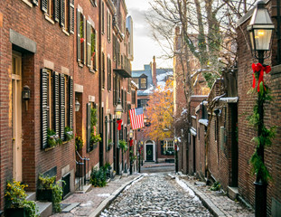 Acorn Street at Christmas Time: Classic "All-American" New England Cobblestone Street, Brick Buildings, and American Flag in Historic Beacon Hill Neighborhood (Winter) - Boston, Massachusetts, USA 