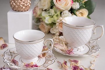 Christmas composition with flowers and white tea cups